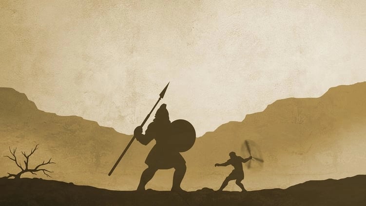 Silhouette of David and Goliath in battle